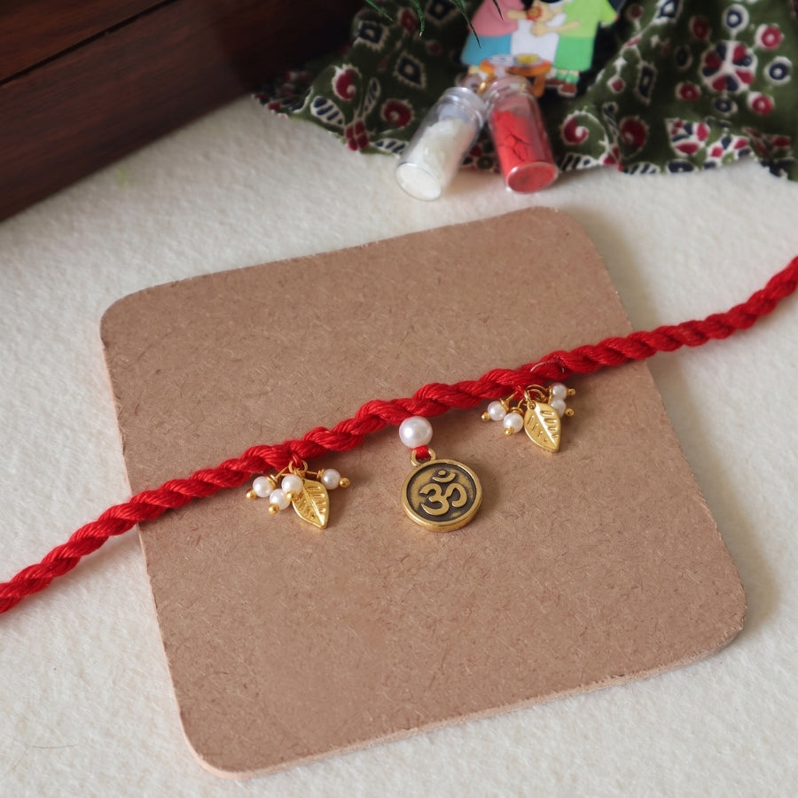 Red Om Charm Braided Rakhi