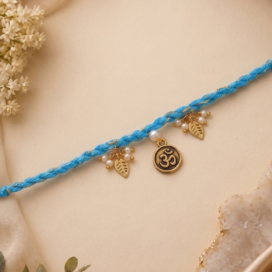 Om Leaf Charm Blue Braided Rakhi