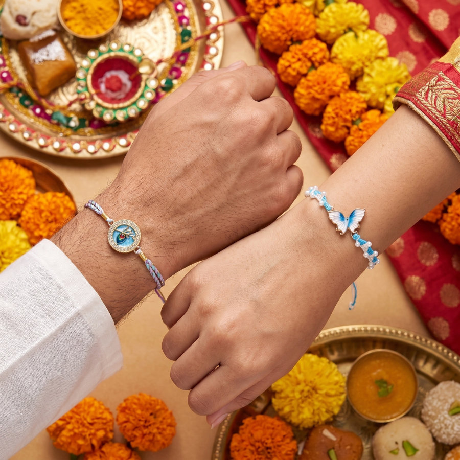 Sky Blue Butterfly Pearl Rakhi & Krishna Mor Pankh Designer Rakhi Set of 2